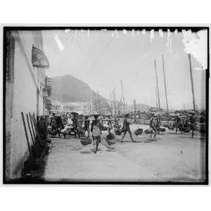  Coolies with basket yokes in Hong Kong harbor