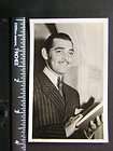 Photo 00105 Clark Gable holds book and smiles past the camera