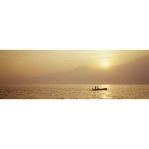 Silhouette of a Fishing Boat in a Lake at Sunrise, Lake Garda, Italy 
