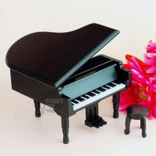 It is a Wind up Piano wooden music box, and have a small Jewelry Box 